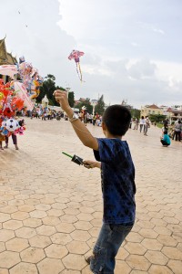 Kid flying a kite near the Cambodian Royal Palace