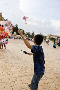 Kid flying a kite near the Cambodian Royal Palace